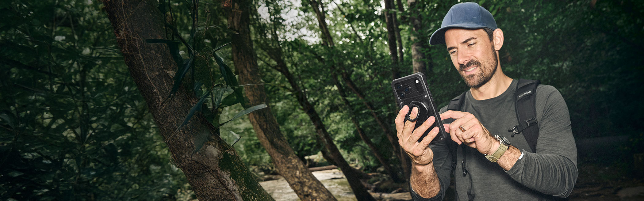 A Pelican phone case mounted on rugged terrain at dusk
